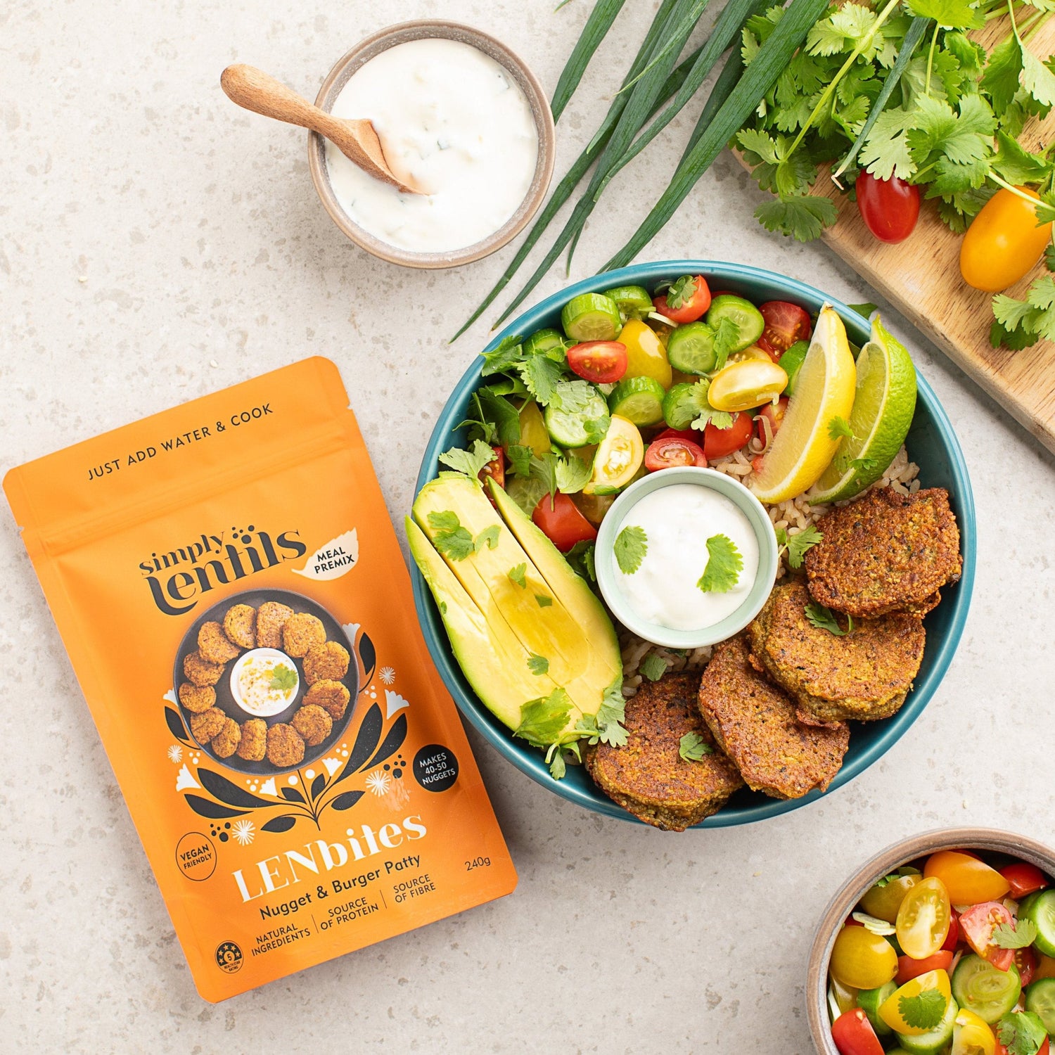 A packet of LENbites and a bowl with salad and lentil nuggets and a sauce